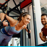 Woman being coached by personal trainer