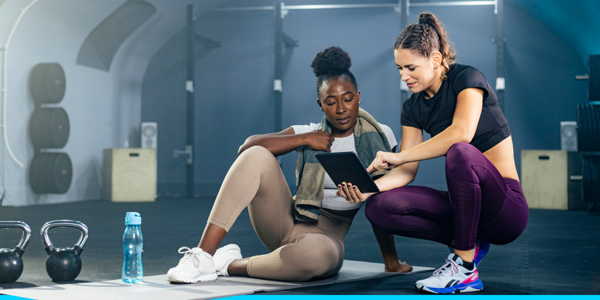 two women looking down at an ipad